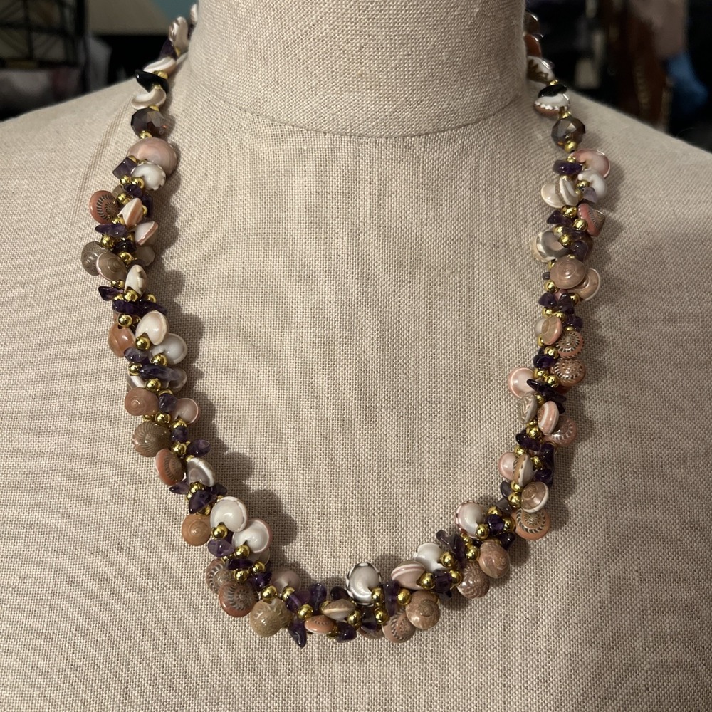multi-strand necklace featuring natural shells, amethyst, and gold-tone beads